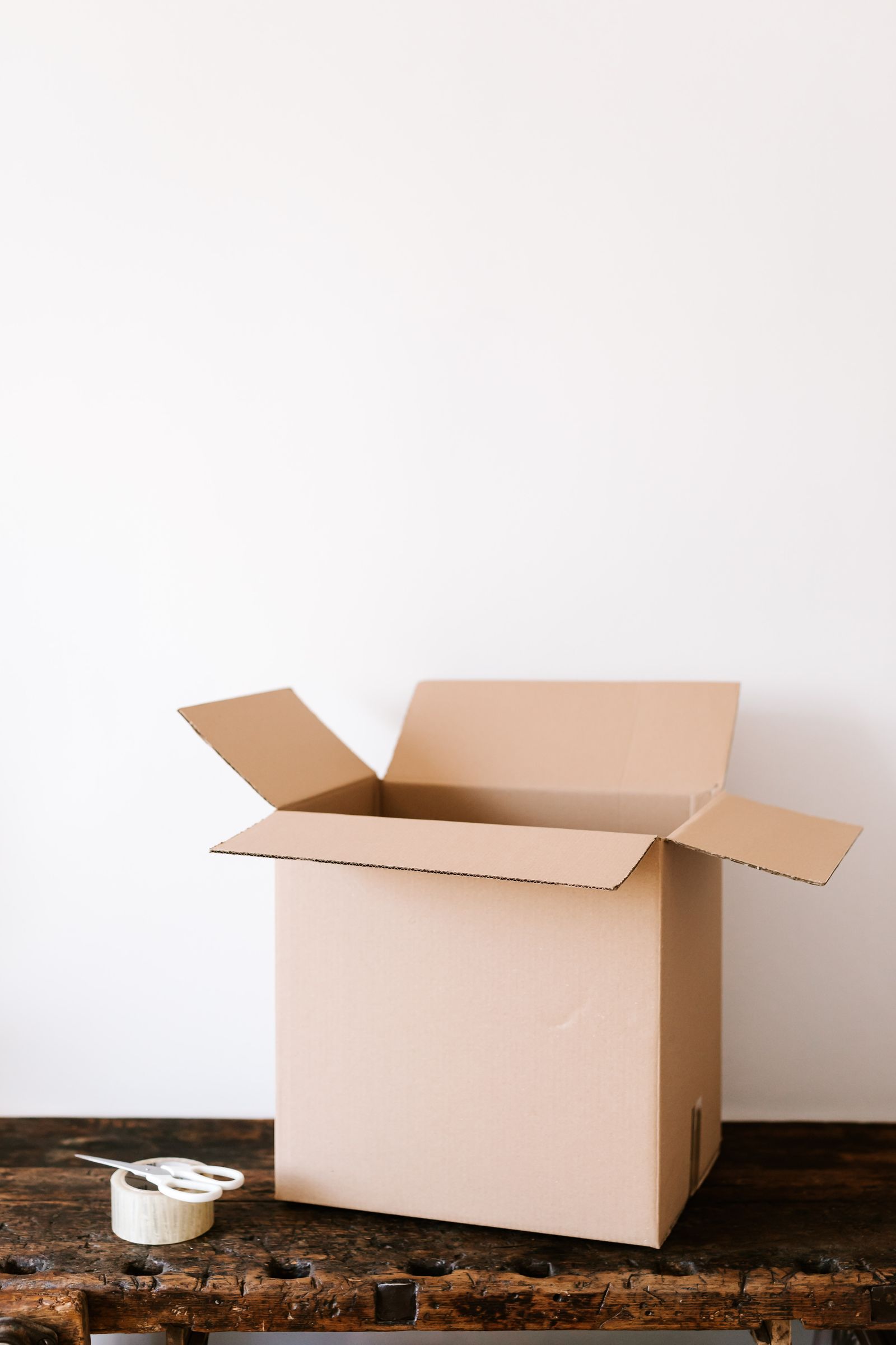 A shipping box and packing supplies ready for an online order